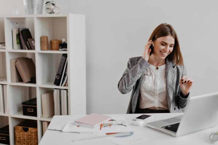 Entrepreneur working remotely while managing payment solutions from her laptop